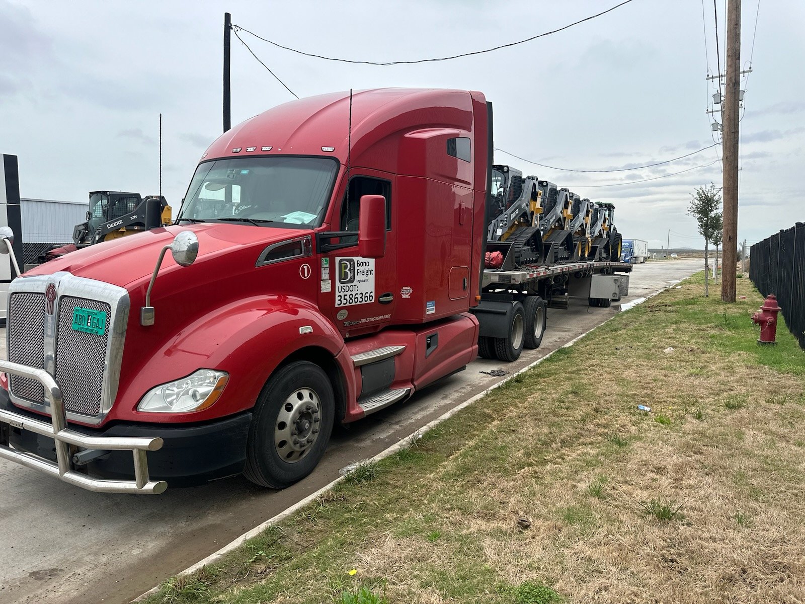 Red truck with a trailer and a heavy load